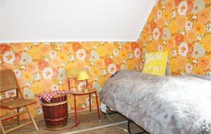 a bedroom with a bed and a table and a chair at Amazing Home In Dale I Sunnfjord in Gjølanger