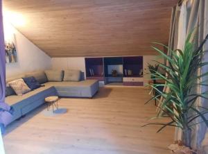 a living room with a blue couch and a wooden ceiling at Apartment Katarina in Hvar