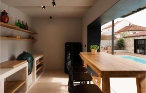 a dining room with a table and a swimming pool at Villa Em in Zadar