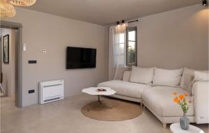 a white living room with a couch and a table at Villa Em in Zadar