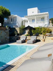 a villa with a swimming pool and a house at Sofos Suites Mykonos in Mikonos