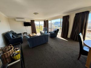 a living room with couches and chairs and a table at Braeview in Lake Tekapo
