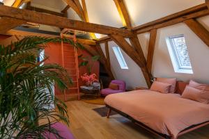 a bedroom with a bed in a room with wooden ceilings at Maison Brunon in Bruges