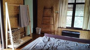 Postel nebo postele na pokoji v ubytování Kiniman Home