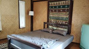Postel nebo postele na pokoji v ubytování Kiniman Home