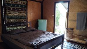 Postel nebo postele na pokoji v ubytování Kiniman Home