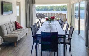 a dining room with a long table and chairs at Stunning Home In Tingsryd With Wifi in Tingsryd