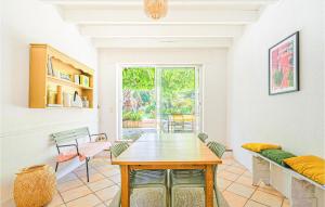 a dining room with a table and a couch at Stunning Home In Médis in Médis