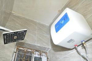 a hair dryer on a wall in a bathroom at Starlight Homes in Asaba +18 photos