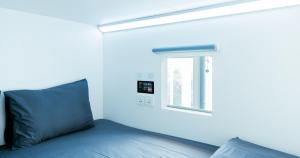 Uma cama ou camas num quarto em Bobopod Kebayoran Baru, Jakarta