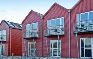 a row of red buildings with balconies on them at Holiday Home Havnevej Ulfborg Ix in Thorsminde