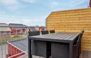 a deck with a table and chairs on a balcony at Holiday Home Havnevej Ulfborg Ix in Thorsminde +20 photos