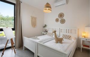 a bedroom with a white bed with a toy dinosaur on it at Villa Eco in Orbani