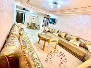 a living room with a couch and a table at Marchica bay 20 holiday apartment in Nador