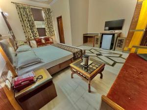 a large room with a bed and a table at Hotel C Park, Karol Bagh, New Delhi in New Delhi