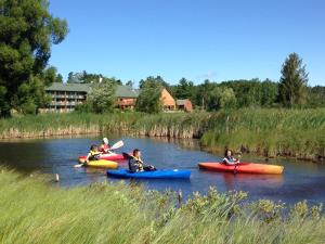 um grupo de pessoas em caiaques num rio em Crooked River Lodge em Alanson