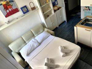 a room with a bed with two pillows on it at Suite Palazzo - Sanremo in Sanremo