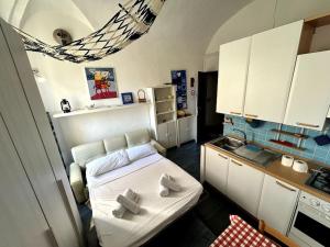 a small kitchen with a bed in a room at Suite Palazzo - Sanremo in Sanremo