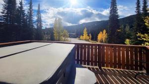 a wooden deck with a view of a mountain at Timberline Village #46 home in Sun Peaks +24 photos