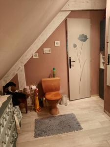 a bathroom with a toilet and a staircase with a door at Chambre d hôte les bosquets in Caugé +30 photos