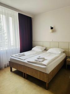 Posteľ alebo postele v izbe v ubytovaní Hotel TM