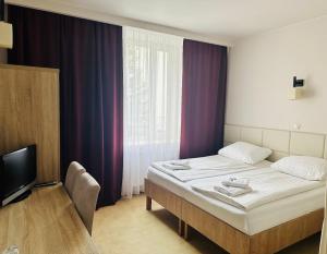 Posteľ alebo postele v izbe v ubytovaní Hotel TM