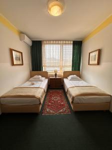 Postel nebo postele na pokoji v ubytování Hotel Grande