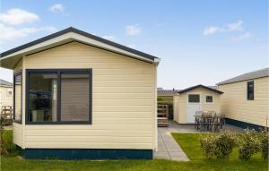 a small shed in a yard with a patio at Lovely Stacaravan In Julianadorp in Julianadorp +6 photos