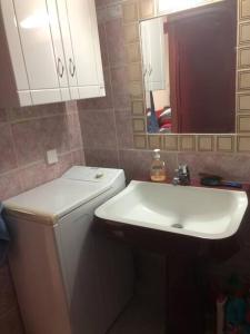 a bathroom with a sink and a toilet and a mirror at Σπιτάκι δίπλα στην θάλασσα! in Chios +9 photos