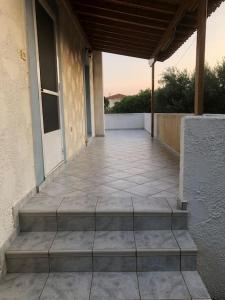 an empty patio with steps leading to a building at Σπιτάκι δίπλα στην θάλασσα! in Chios