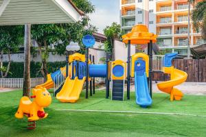 a playground with a blue and yellow slide at Heeton Concept Hotel Pattaya by Compass Hospitality in Pattaya Central