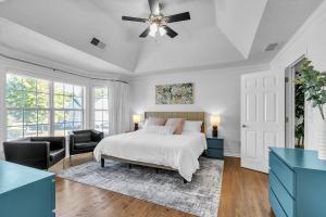 a bedroom with a bed and a ceiling fan at Modern 6BR Haven with Playroom, Gym & Deck! home in Cartersville
