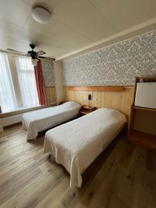 Ένα ή περισσότερα κρεβάτια σε δωμάτιο στο Hotel Breitner