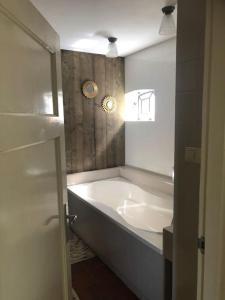 a bathroom with a large tub and a sink at Appartement voor twee personen in Twisk +43 photos