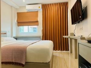 a hotel room with a bed and a window at Icon Dome Bangkok in Bangkok
