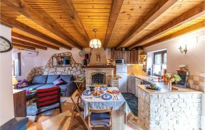 a kitchen and living room with a table and a fireplace at Two-Bedroom Holiday Home In Drvenik Veli in Veliki Drvenik