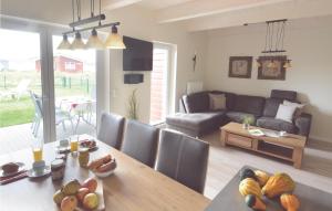 a living room with a table and a couch at Gorgeous Home In Dagebüll With Sauna in Dagebüll +25 photos