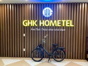 a bike parked in front of a wall with a sign at Gia Hưng Khang Hometel in Ha Long