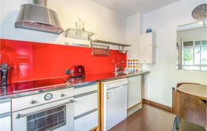 a red kitchen with a stove and a sink at Nice Home In San Javier With Wifi in San Javier
