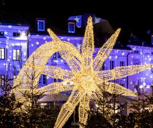 a christmas lighted star in front of a building at Loft l'Alessandra in Bolzano