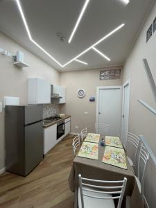 a kitchen and dining room with a table and chairs at Casa Miriam 281 in Palermo +32 photos