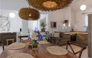 a dining room table with a vase of flowers on it at Villa Toscana in Umag