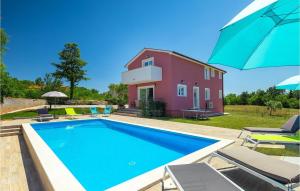 a villa with a swimming pool in front of a house at Villa May in Poreč