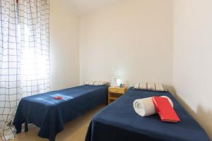 A bed or beds in a room at Appartamento La Pineta Nord - MyHo Casa