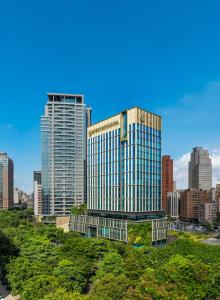 a tall building in the middle of a city at InterContinental Taichung by IHG in Taichung
