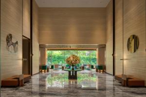 a lobby with a table with a vase of flowers at InterContinental Taichung by IHG in Taichung