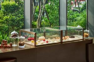 a display of pastries on a counter with a window at InterContinental Taichung by IHG in Taichung
