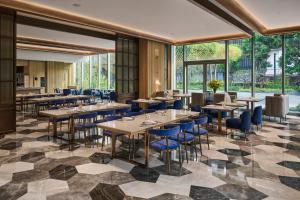 a restaurant with tables and chairs and windows at InterContinental Taichung by IHG in Taichung