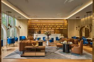 a lobby with tables and chairs and a library at InterContinental Taichung by IHG in Taichung