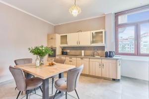 a kitchen with a wooden table and chairs at Lisa 3, Guestroom-WG-Zimmer Eggert in Pforzheim +11 photos